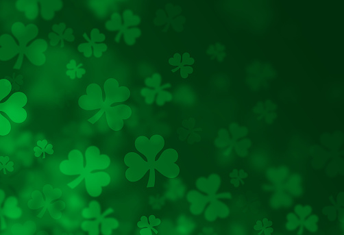 Shamrock four-leafed clover St. Patrick's Day with green design background.