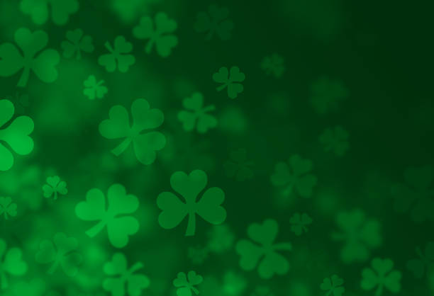 Four-Leafed Clover Shamrock St. Patrick's Day Textured Green Background Shamrock four-leafed clover St. Patrick's Day with green design background. st. patricks day stock illustrations