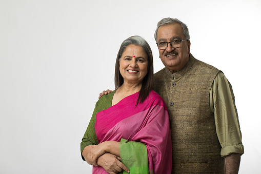 Portrait of loving senior Indian couple posing in traditional clothing