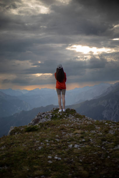 istock Young woman enjoying beautiful view from mountain top 1451083527