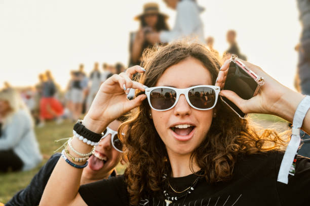 Teenagers goofing around at music festival stock photo