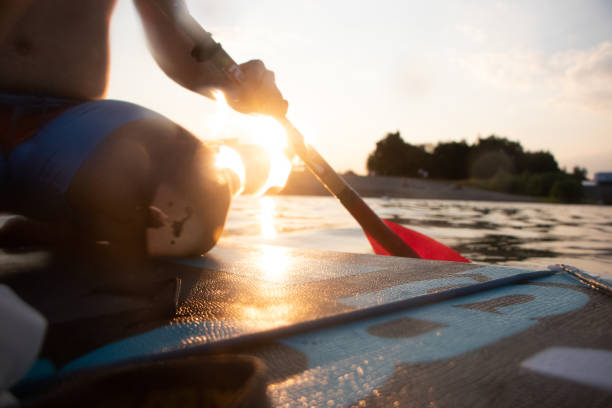istock Man paddling on stand up paddleboard on lake 1451085538
