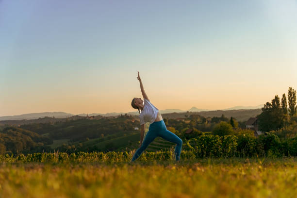 istock Female yogi practicing viparita virabhadrasana on landscape 1451087259