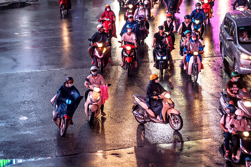 busy night street with motorbikes and cars in Ho Chi Minh City, Saigon, Vietnam