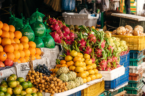 A colorful array of fruits and vegetable displayed for sale at the market\nHue, Vietnam