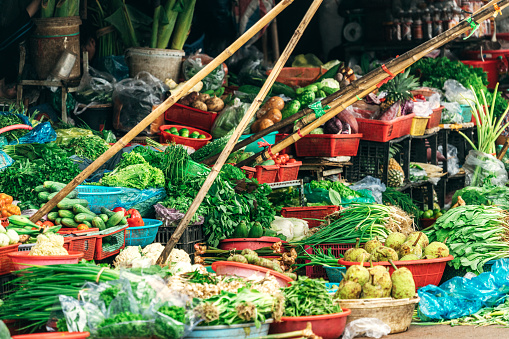 A colorful array of vegetable displayed for sale at the market\nHue, Vietnam