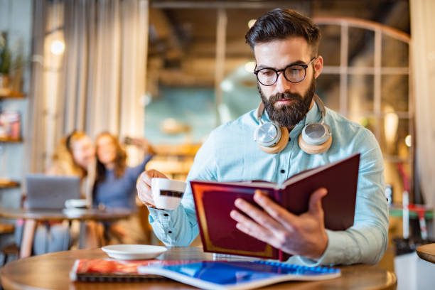 istock Men reading a book in university cafe 1451093837