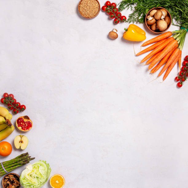 istock Square frame, border with raw fresh vegetables and fruits on table, copy space 1451094193
