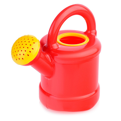Children's plastic watering can for playing in the sandbox or in the garden. Color watering can for watering flowers, highlighted on a white background, close-up.