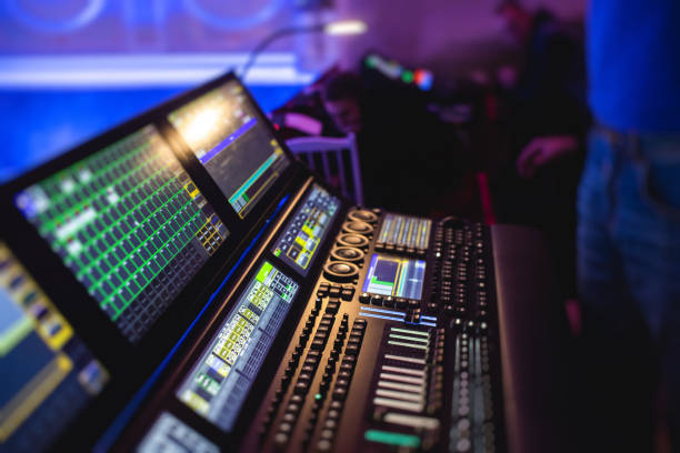 istock View of lighting technician operator working on mixing console workplace during live event concert on stage show broadcast, light mixer controller panel, sound technician with professional equipment 1451098851