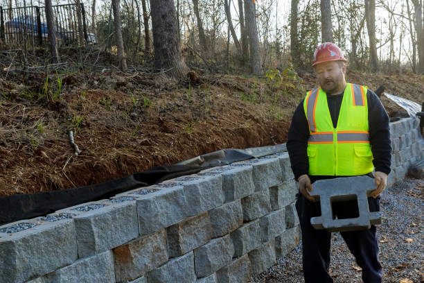 istock During the construction of a retaining wall on a new property, a construction worker is building retaining blocks 1451099078