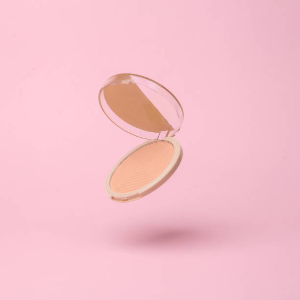 istock Powder box flying in antigravity on pink background with shadow. Levitation object in the air. Beauty and fashion concept. Creative minimalist layout 1451103893