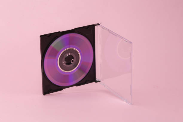 istock Cd disk in box flying in antigravity on pink background with shadow. Levitation object in the air. Creative minimal layout 1451103922