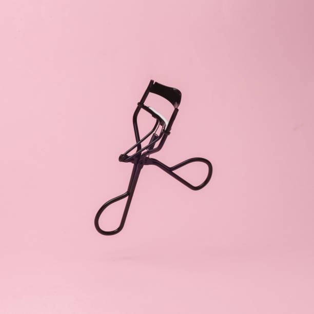 istock Professional eyelash curler  isolated on pink background 1451103968