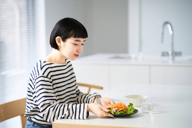 istock woman eating at home dining 1451104065
