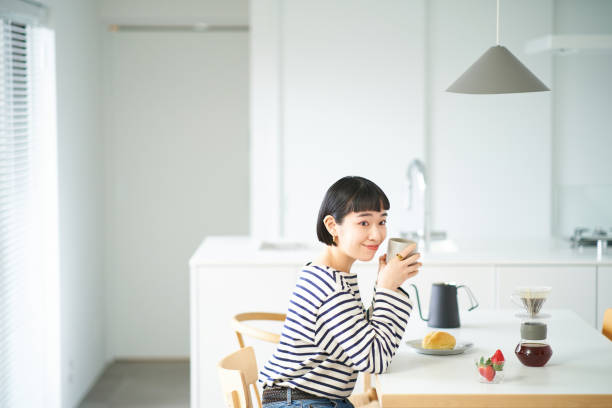 istock woman drinking coffee in the room 1451104327