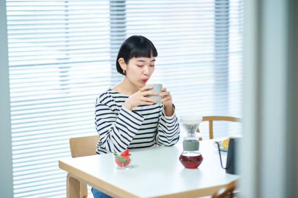istock woman drinking coffee in the room 1451104546