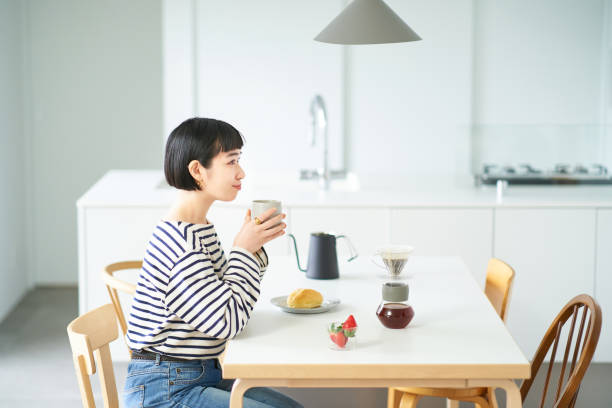 istock woman drinking coffee in the room 1451104688