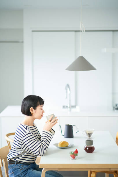 istock woman drinking coffee in the room 1451104863