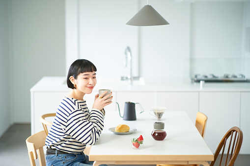 Young woman drinking coffee in the room