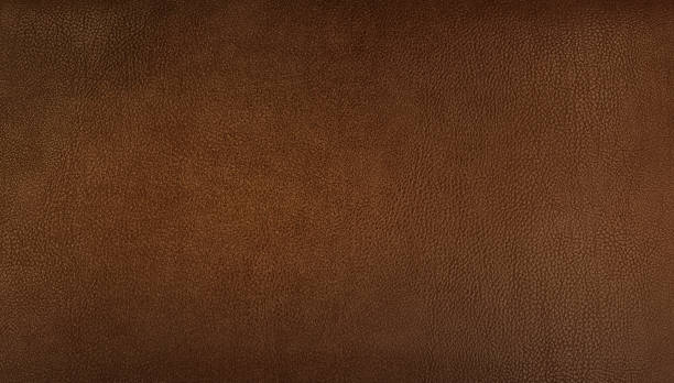 istock brown genuine leather texture background for vintage, classic concept. light brown background for decorations and textures. dark orange, brown color leather skin natural with design lines pattern. 1451105624
