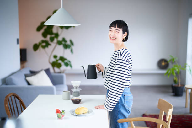istock woman brewing coffee in her room 1451105734