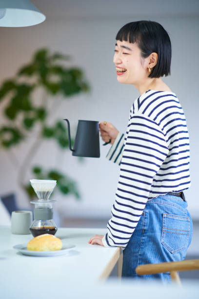 istock woman brewing coffee in her room 1451106113