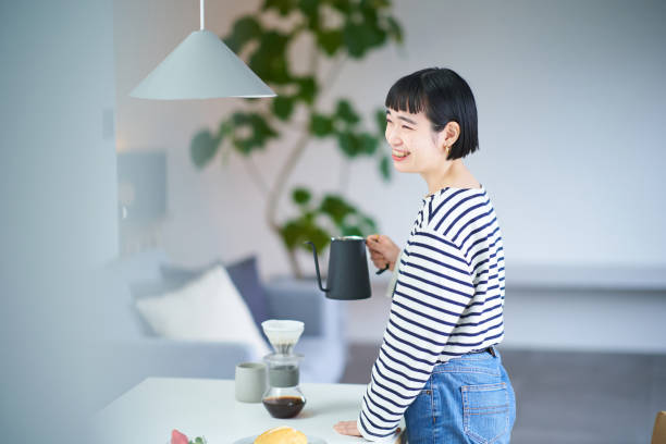 istock woman brewing coffee in her room 1451106581