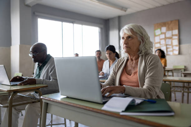 istock Senior woman using a laptop while taking a class in college 1451106858