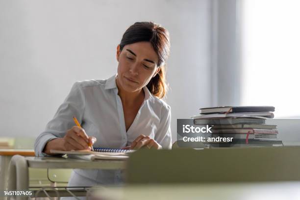Adult Woman Going Back To School And Writing In Her Notebook Stock Photo - Download Image Now
