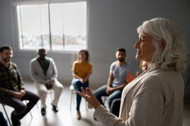 istock Woman talking in a group therapy session 1451107454