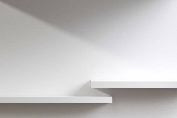 istock Empty white square pedestals with sunlit shadows, wall shelves. 1451107506