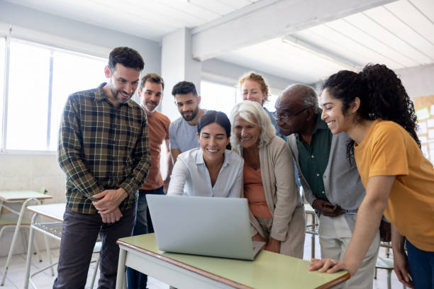 istock IT teacher with a group of students in class 1451108302