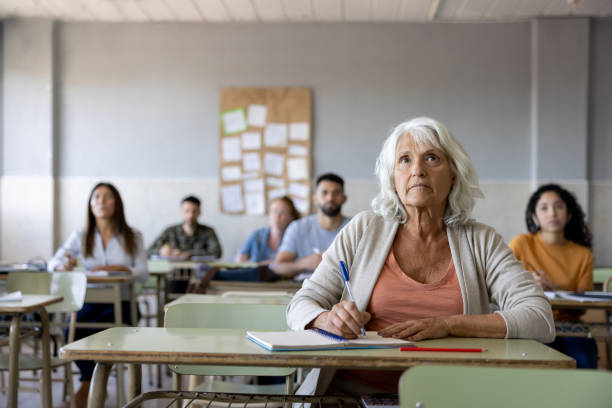 istock Senior woman taking a class in college 1451108376