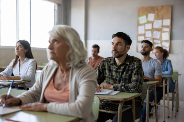 istock Group of college students paying attention in class 1451108395