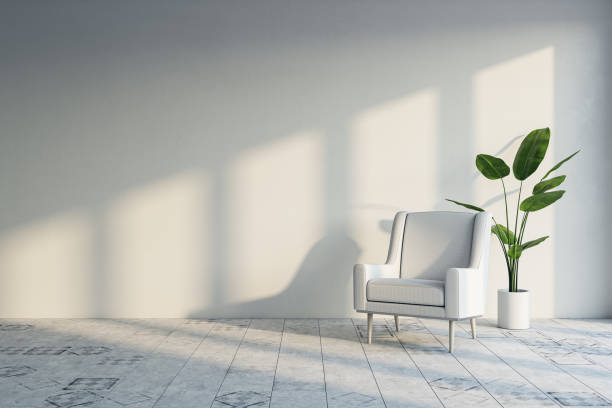 istock Modern empty room interior with shadows and sunlight, armchair and decorative plant, mock up place on concrete wall. 3D Rendering. 1451108481