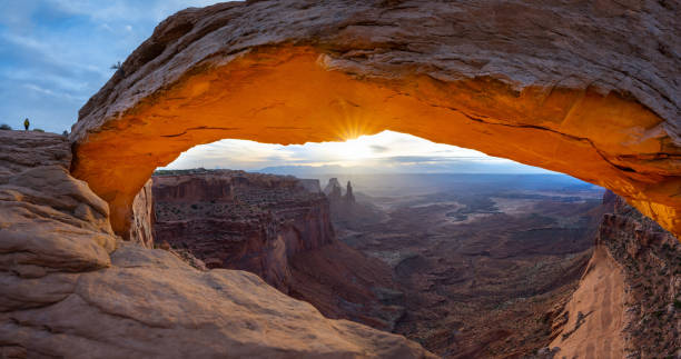 Mesa Arch Sunrise The sunrise at the Mesa Arch in the Canyonlands National Park makes the arch glow, Utah, USA. natural landmark stock pictures, royalty-free photos & images