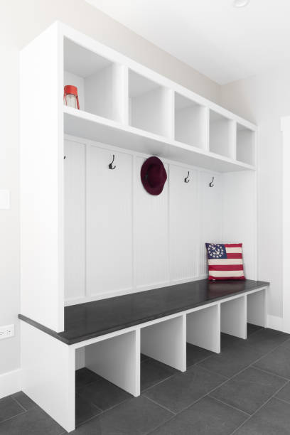 istock A white mud room foyer with a dark grey floor and seating. 1451109978