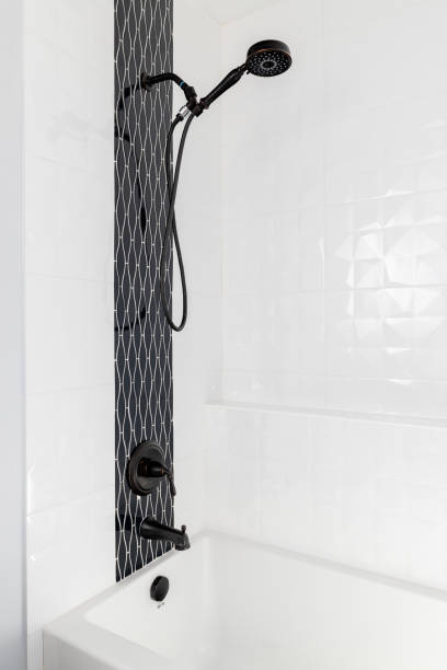 istock A shower and bathtub with black and white tiles. 1451109987