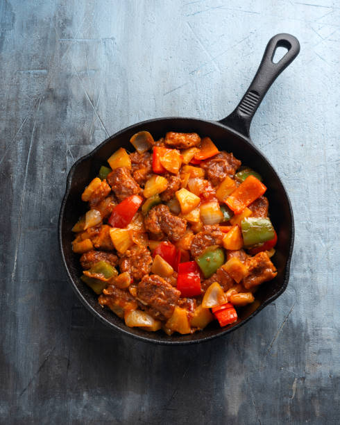istock Sweet and Sour Pork with bell pepper, pineapple in iron cast pan 1451114909