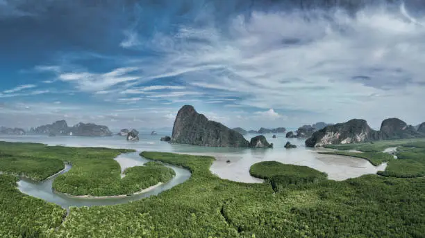Phang Nga Bay Islands Scenic Drone Point of View. Beautiful Islands in the Andaman Sea towards the horizon under blue summer skyscape. Iconic View over Mangrove Forest at the coast of the thai Andaman Sea Islands. Phang Nga Bay, Phuket, Thailand, Southeast Asia, Asia.