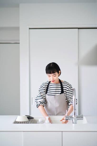 istock Woman washing dishes in the kitchen 1451115251