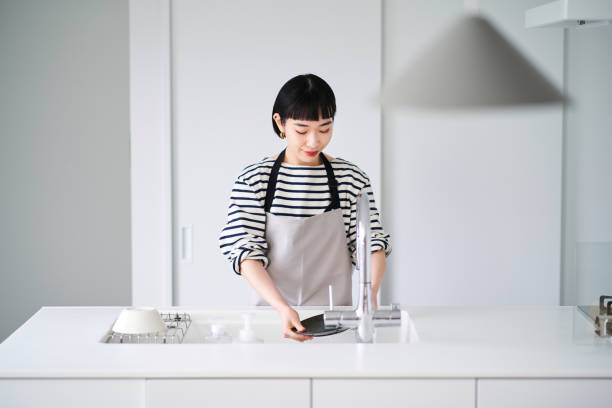 Woman washing dishes in the kitchen
