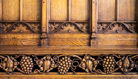 Decorative carved woodwork on a screen in the Church of St Peter & St Mary in Stowmarket, Suffolk.