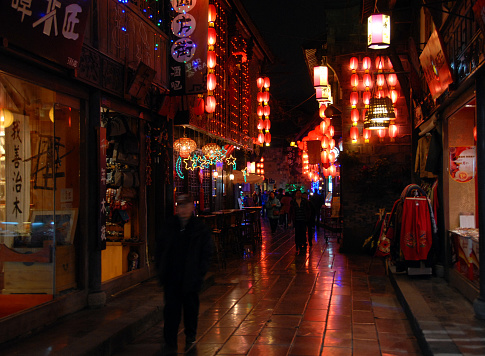 Jinli Ancient Street in Chengdu, Sichuan Province, China.  Jinli Street has cafes and bars and is decorated with red lanterns. It's a fun place to stroll and eat at night in Chengdu.