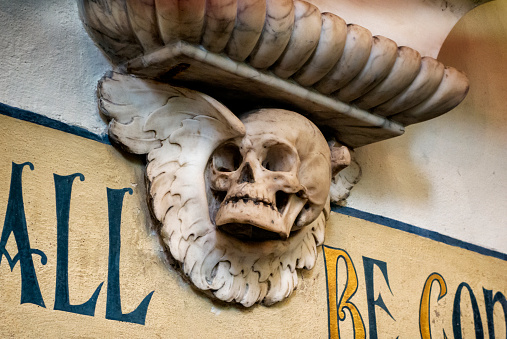Part of a cheery decorative element on a Victorian memorial plaque inside a former church in Ipswich, Suffolk. Probably to remind all who look at it that death comes to us all!