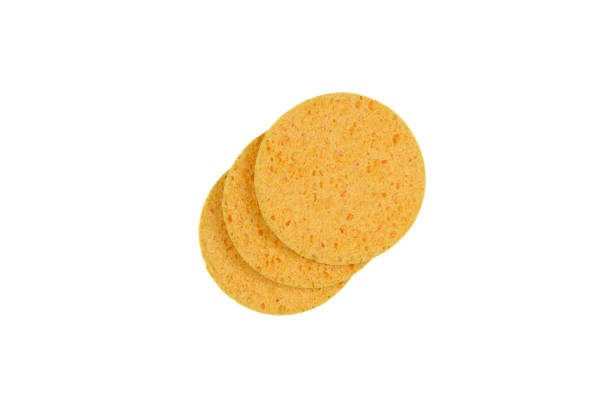 istock Three round yellow face sponges highlighted on a white background. 1451121888