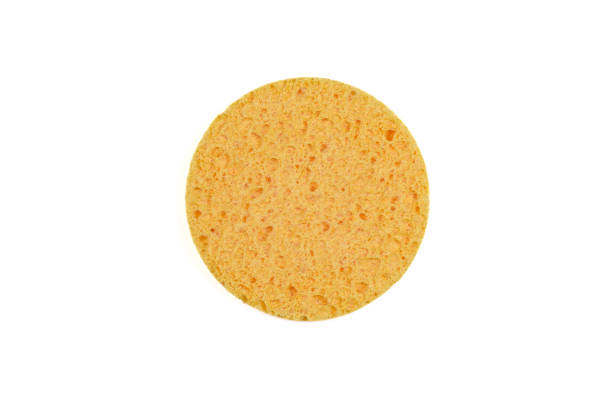 istock Round yellow sponge for the face, isolated on white. 1451121893