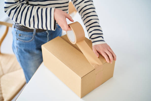 istock Young woman packing a cardboard box 1451122622