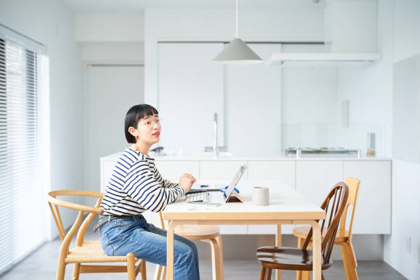 istock Young woman working at table in room 1451124493
